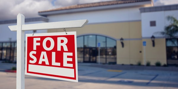 Property with a for sale sign in the front