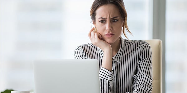 woman with laptop skeptical about business email compromise