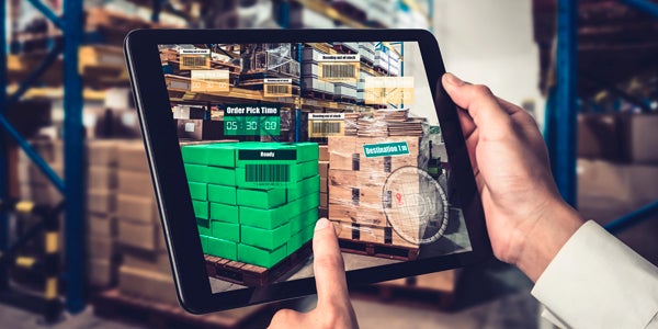 Worker uses tablet to view warehouse section