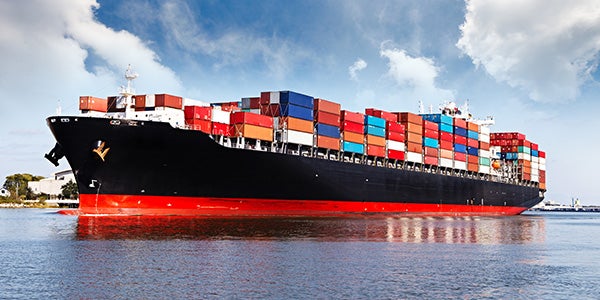 Cargo ship transporting goods through canal